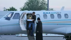 В Алматы доставили Благодатный огонь из Иерусалима